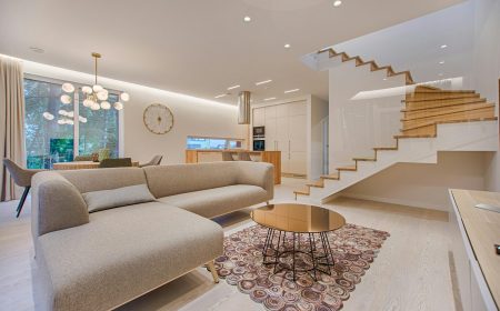 pexels photo 1571460 1571460 Contemporary living room with neutral tones, a sleek sofa, and elegant wooden staircase.
